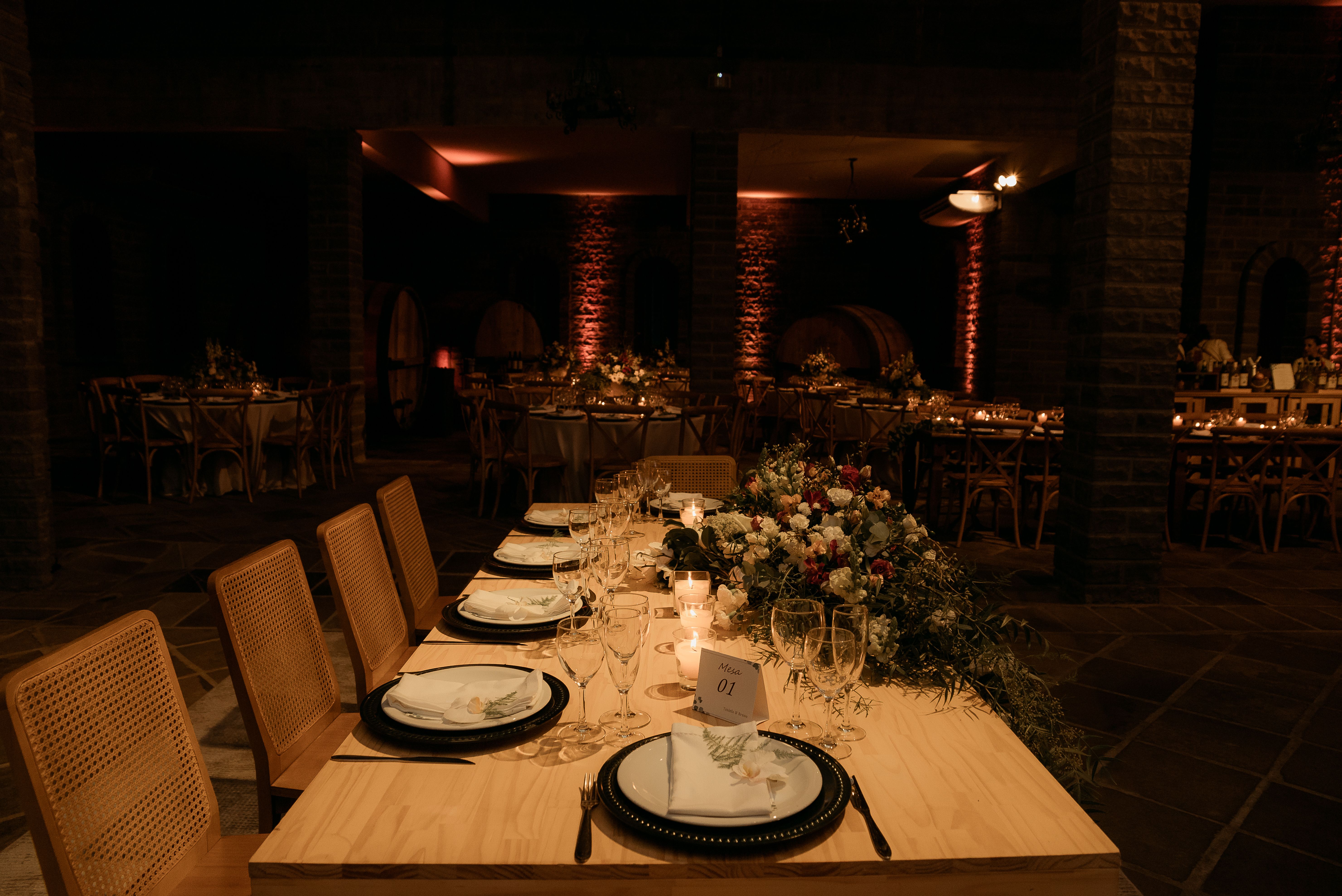 Candlelit wedding dinner setup in a warm, atmospheric venue