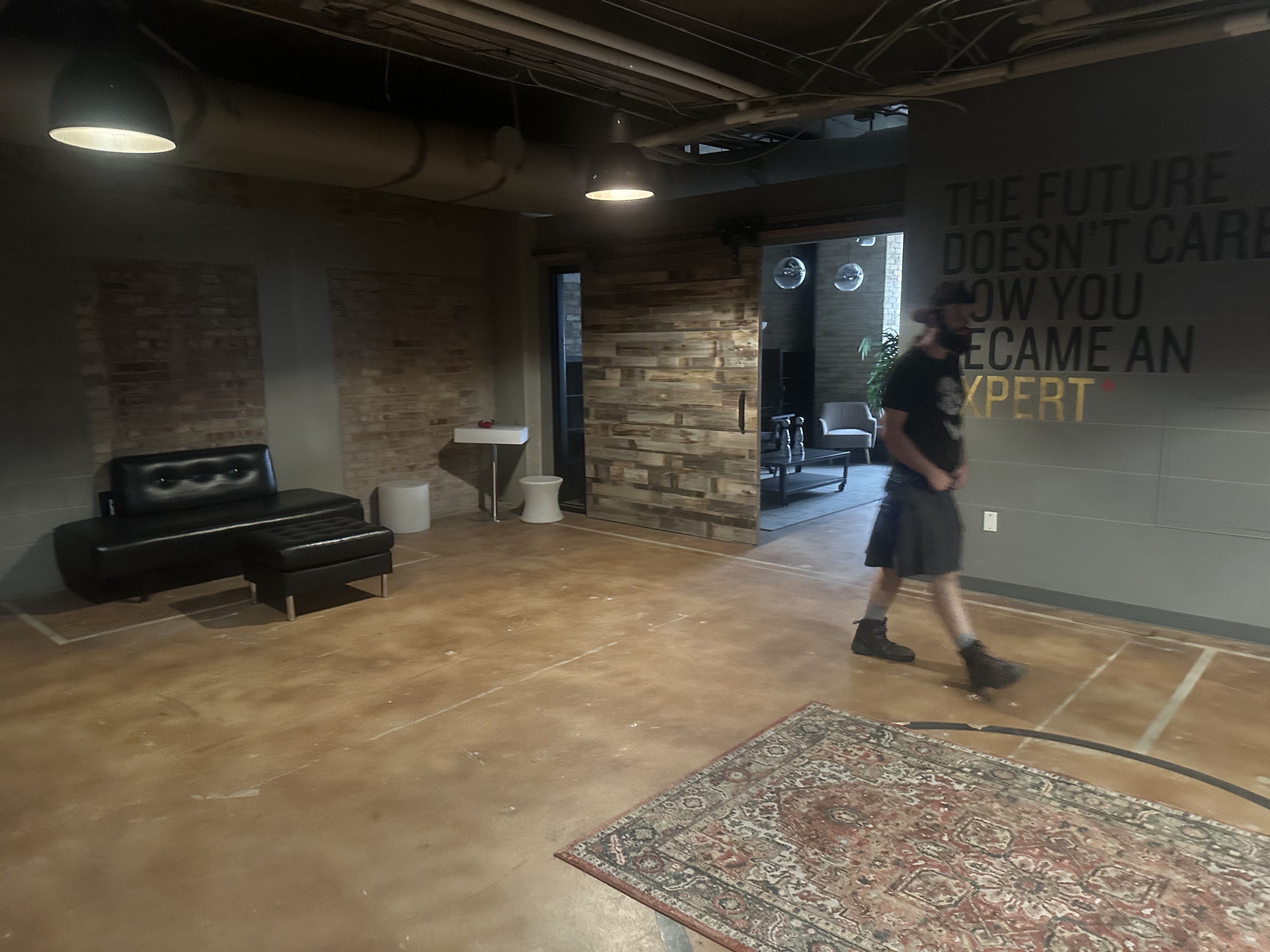 Studio320 interior with brick, wood, lounge seating, and an open floor