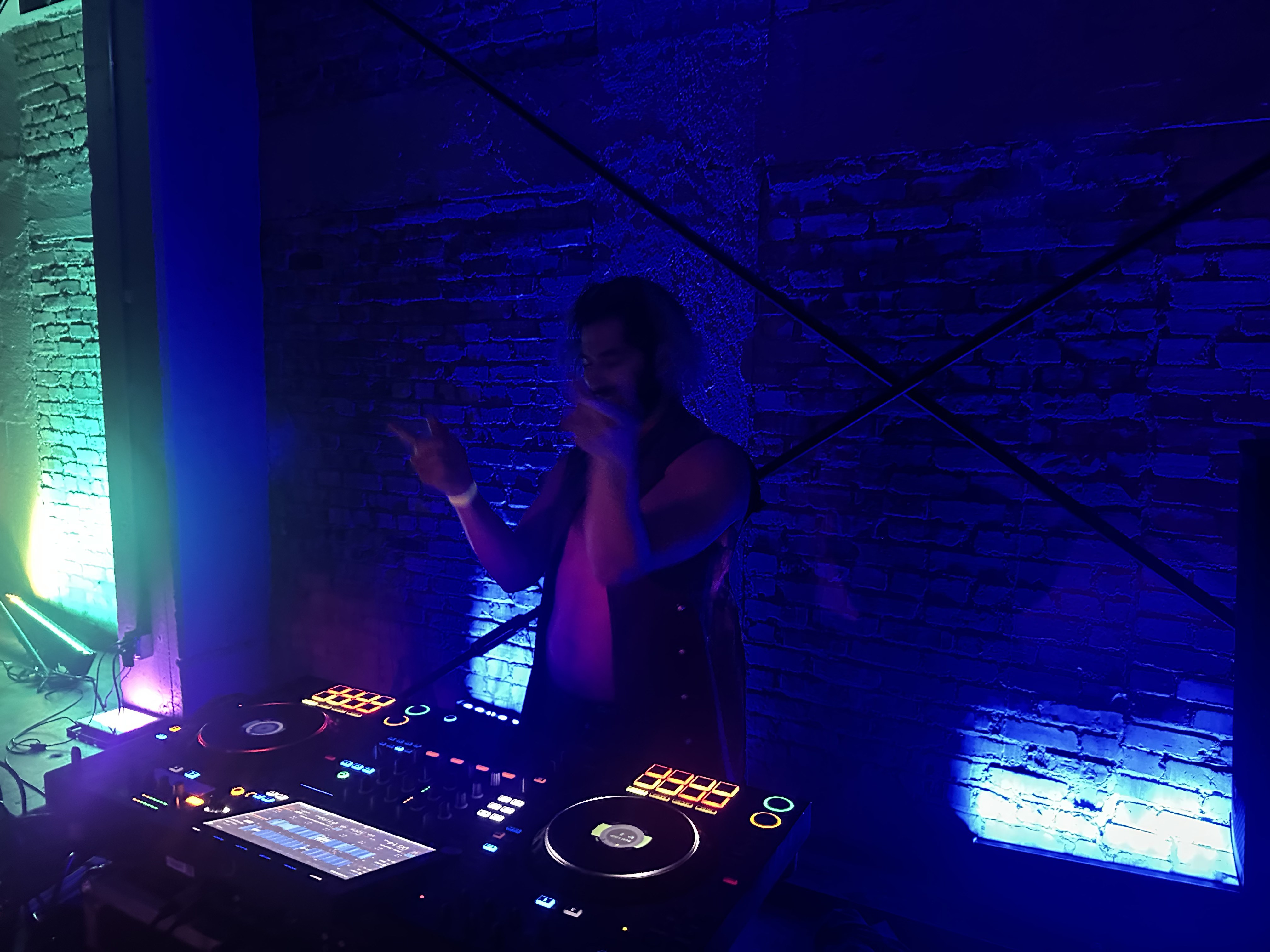 DJ performing under blue light at Studio320